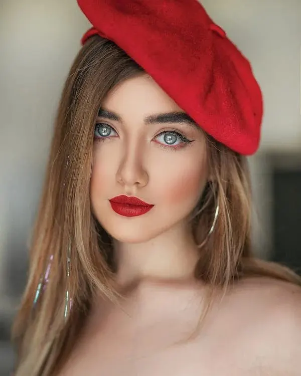 Woman in a bold red beret capturing the spirit of confident Australian racing fashion