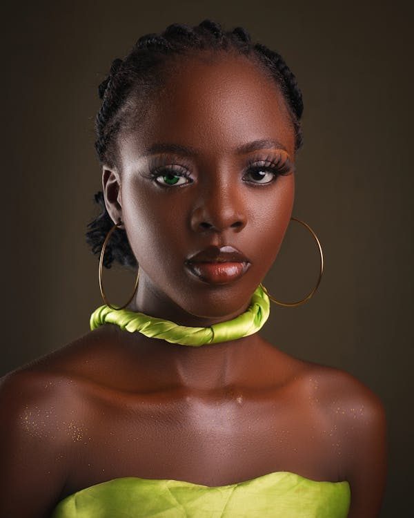 Striking portrait of a woman with bold ornate headpiece accessories and rich styling