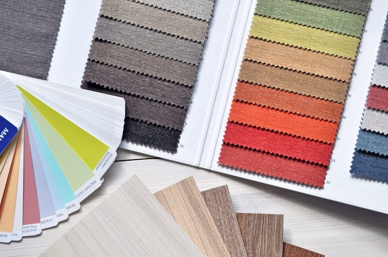 Colourful fabric and material swatches arranged for selection reflecting the colour-matching process in bespoke millinery