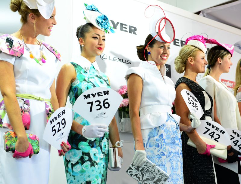 Fashions on the Field competitors showcasing racing outfits and millinery at Flemington Racecourse