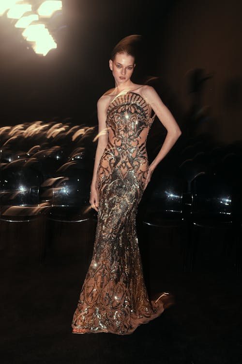 Elegant model showcasing a glamorous evening gown at a luxury fashion event in the style of Dubai World Cup