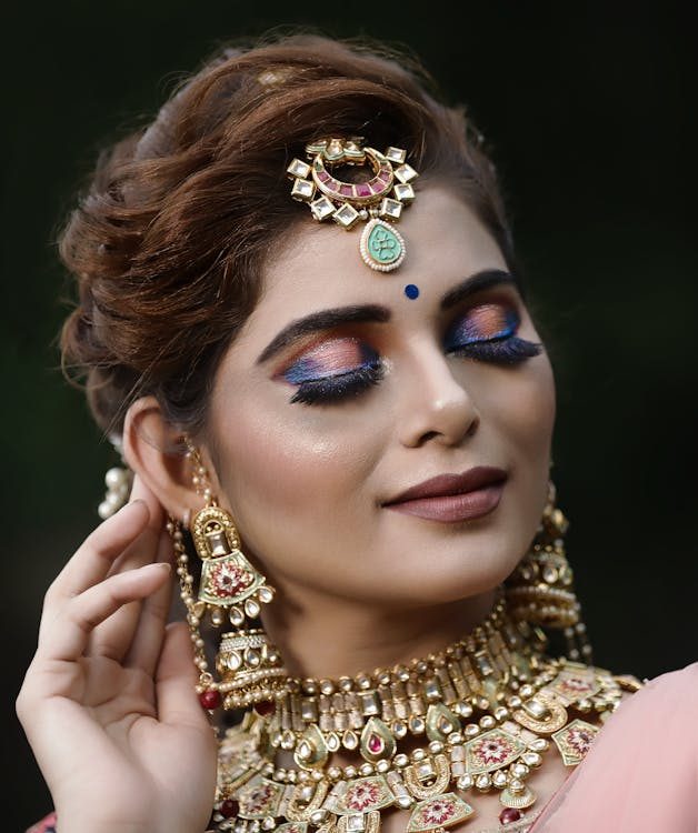 Woman wearing gold accessories and metallic jewellery evoking luxury desert glamour