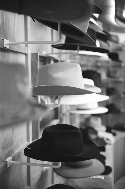 Hats displayed on stands in a store showing proper hat storage and display techniques