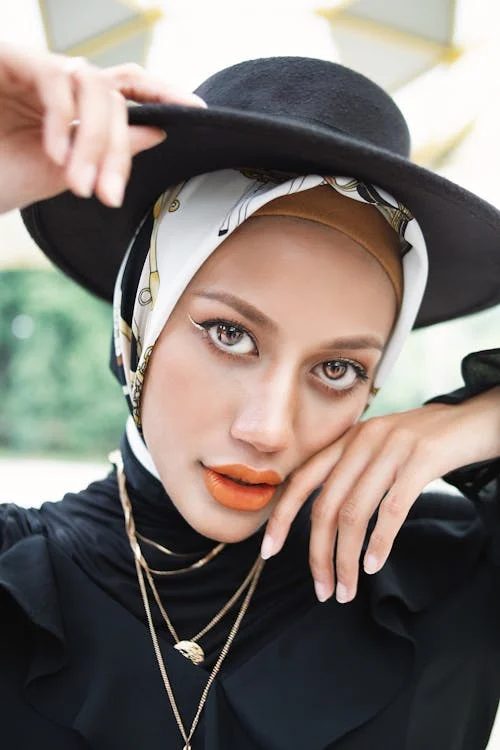 Elegant woman wearing a black hat in a monochrome fashion portrait evoking the classic Oaks Day black-and-white dress code
