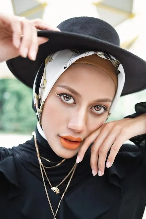 Woman wearing a classic structured dark hat capturing the refined elegance of Royal Ascot dress code