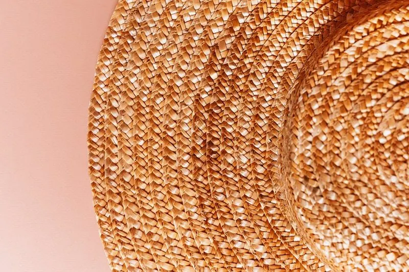Natural woven straw hat close-up the perfect summer garden party accessory