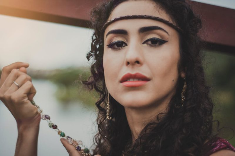 Woman wearing a delicate elegant headband with understated sophistication showing how subtle millinery elevates an outfit