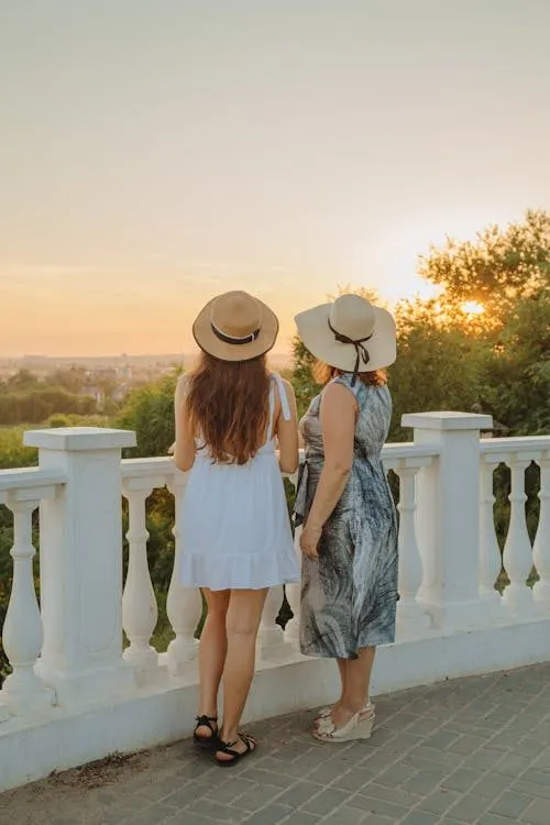 Women wearing elegant hats viewed from behind showcasing stylish wedding guest headwear