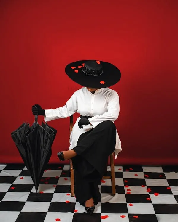 Elegant woman in a statement black hat demonstrating sophisticated wedding guest millinery style