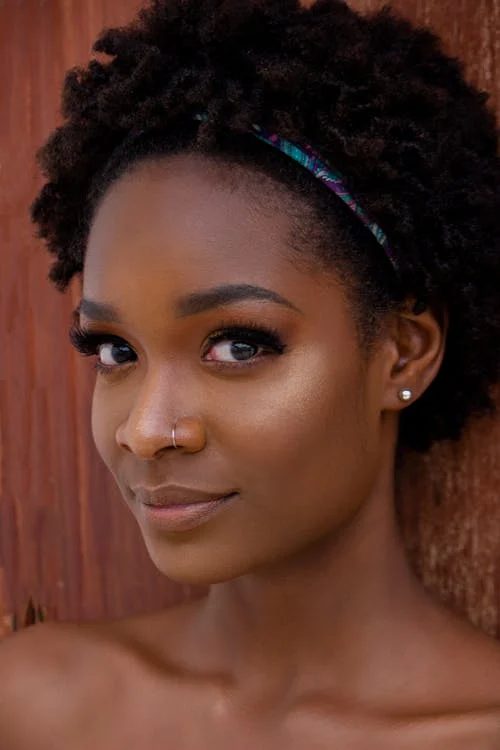 Portrait of a woman wearing and adjusting her decorative headband showing how to position for comfort and style