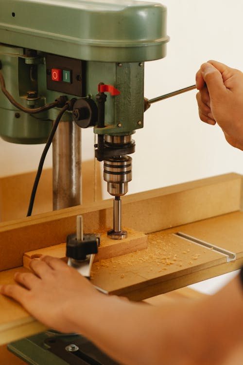 Close-up of a wooden block in an artisan workshop showcasing the smooth carved form used as a mould for shaping hats