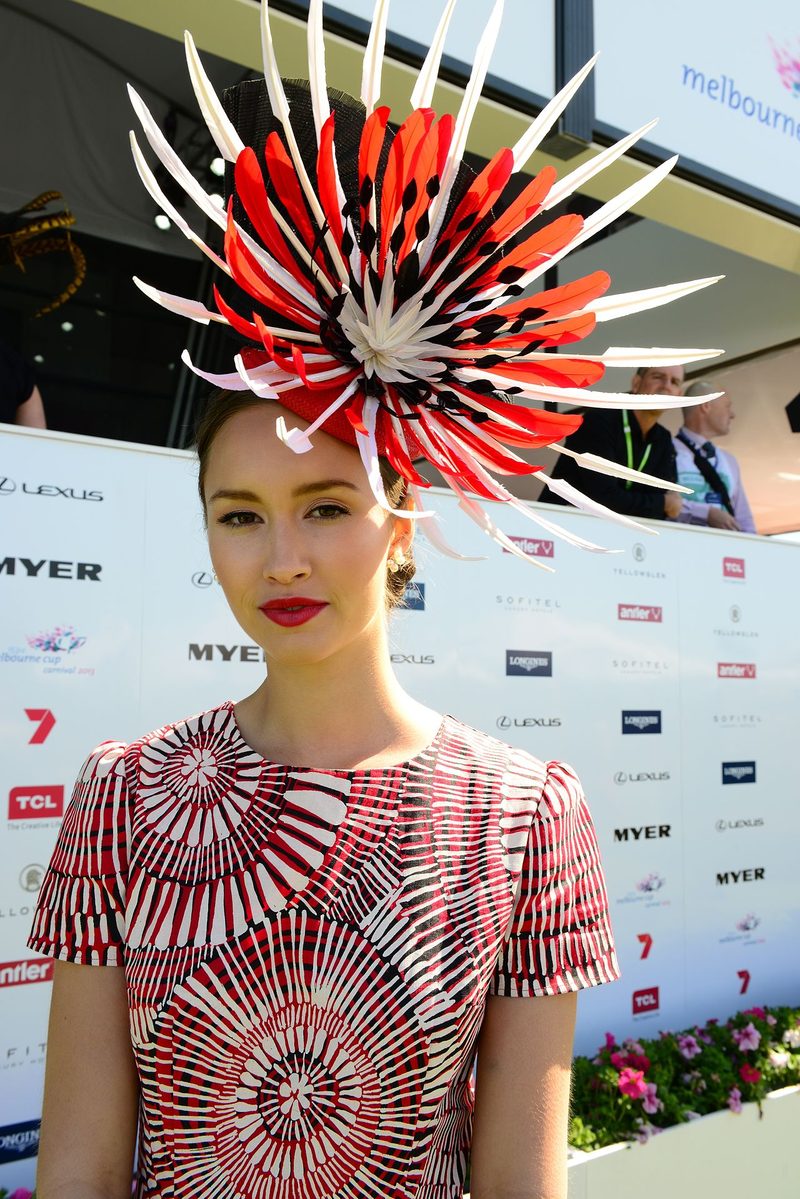 Melbourne Cup Fashions on the Field winner wearing a bespoke fascinator showcasing summer racing style with a red and white printed dress