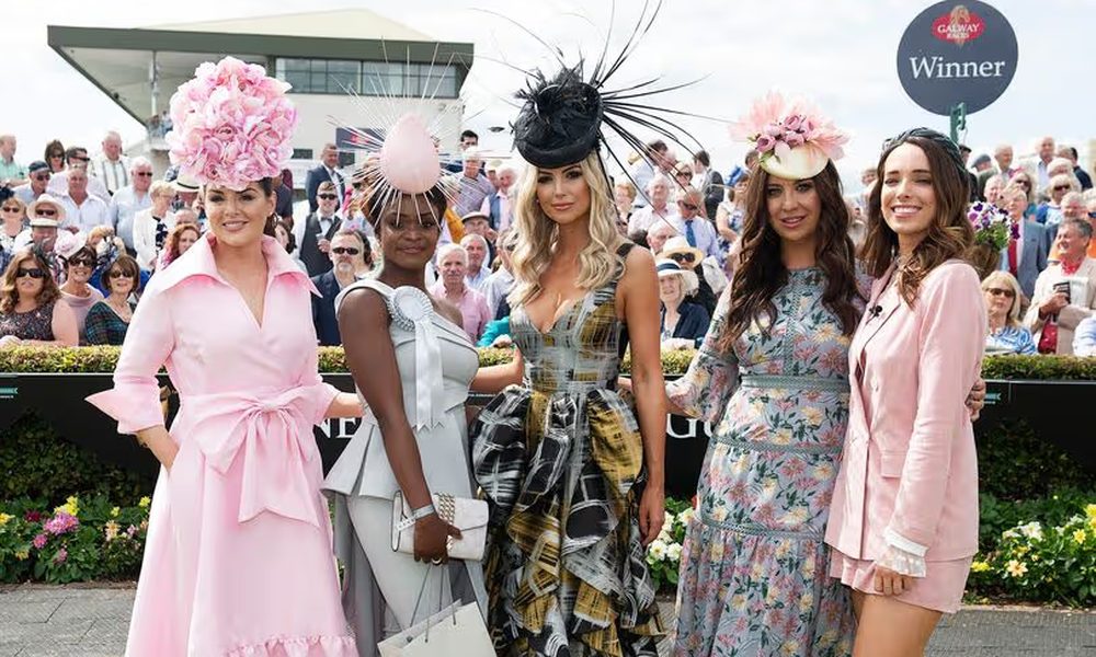 Ladies day racing fashion winners wearing dramatic pink floral hats and elegant outfits at the races
