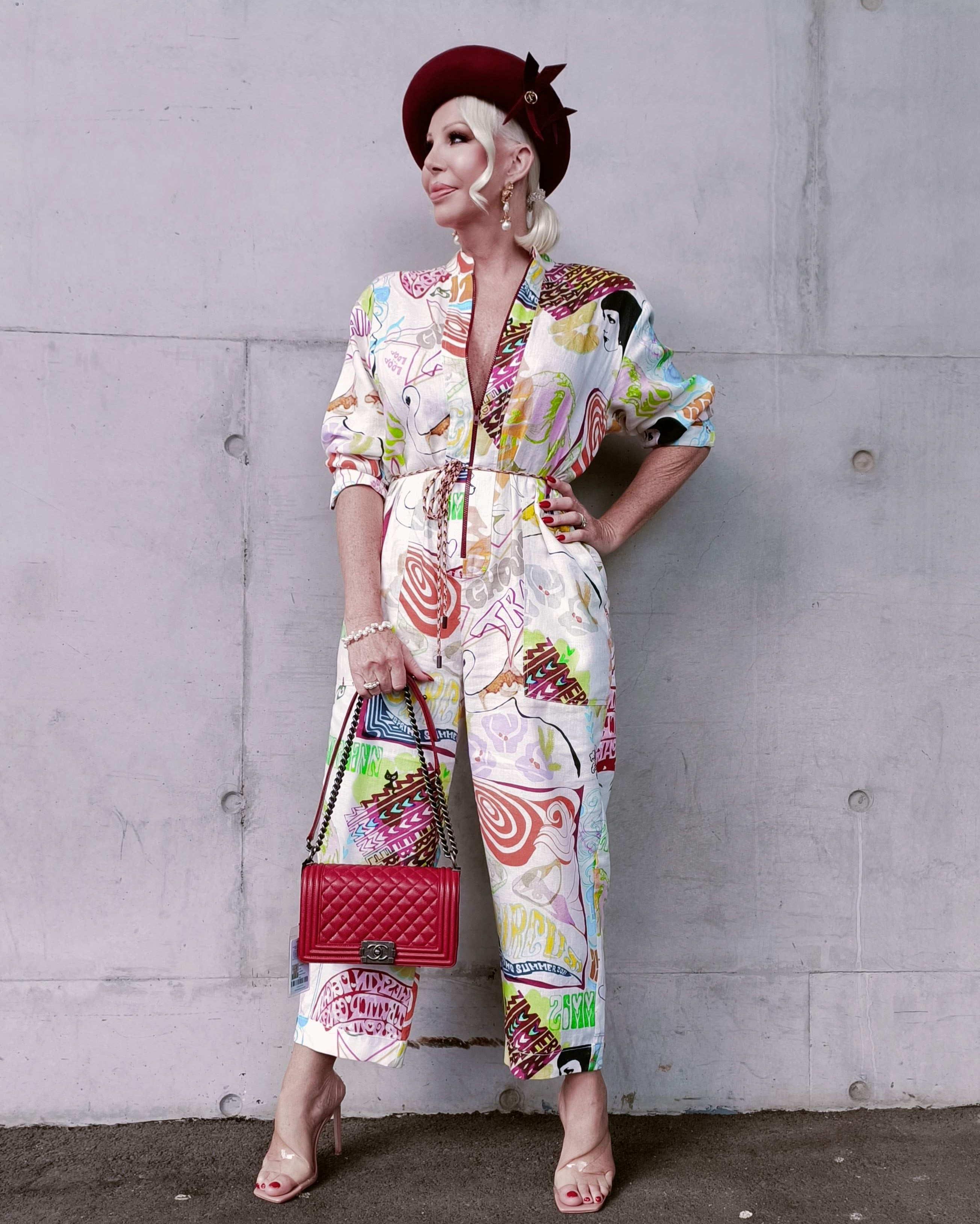 Burgundy beret by Kathryn Lee Millinery paired with colourful printed jumpsuit for spring racing fashion