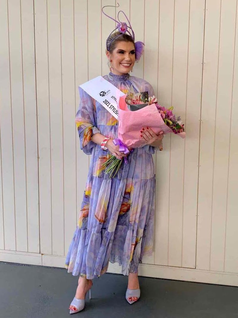 2021 Stylish Lady winner wearing KLM lavender fascinator headpiece with floral dress at racing carnival