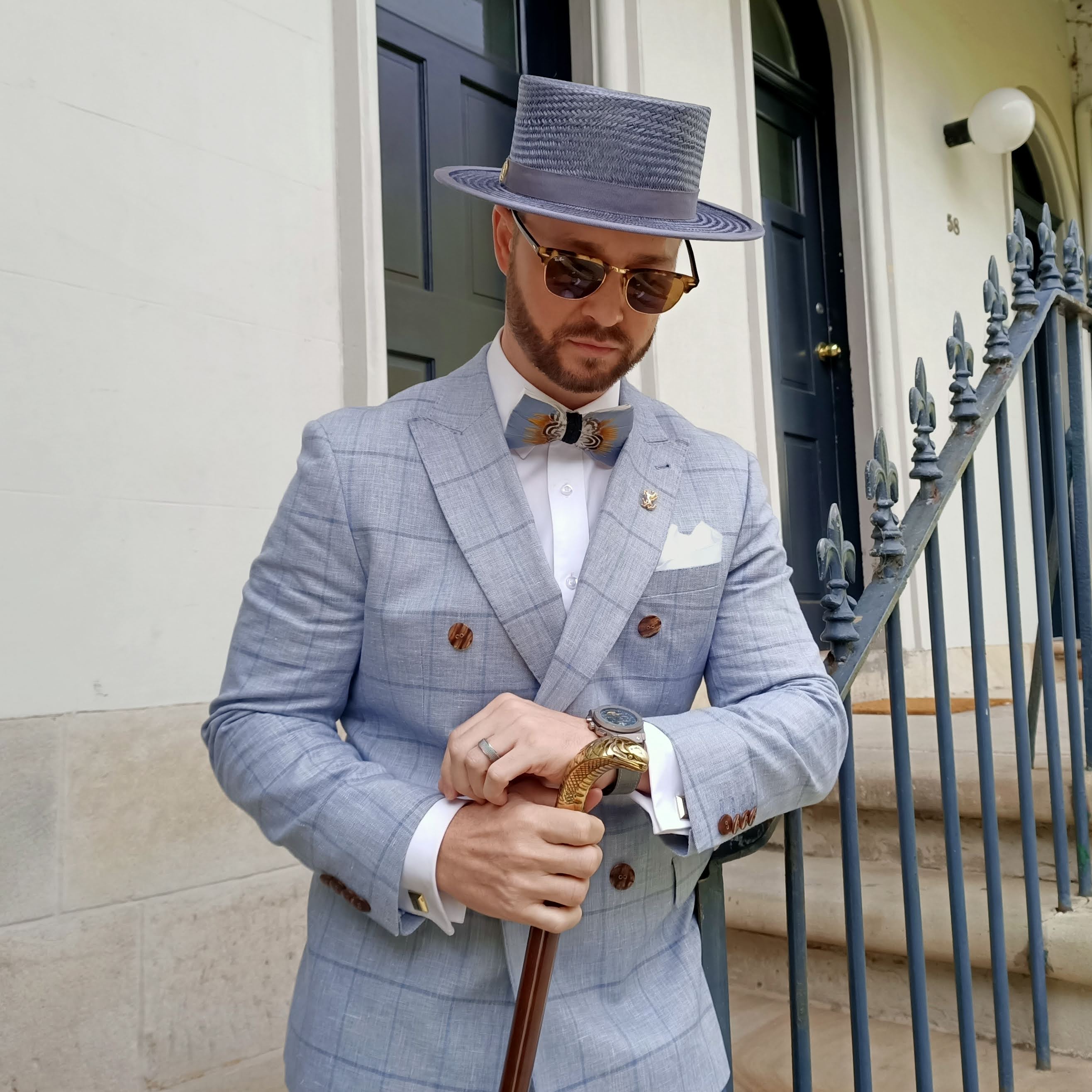 Grey straw boater hat by Kathryn Lee Millinery with blue windowpane suit - mens race day style