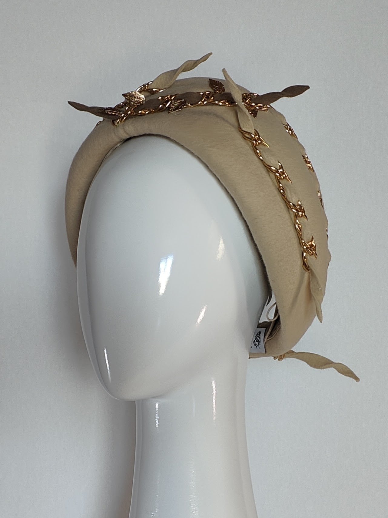 Gold Hayley turban crafted from felt – luxury racing headwear by Kathryn Lee