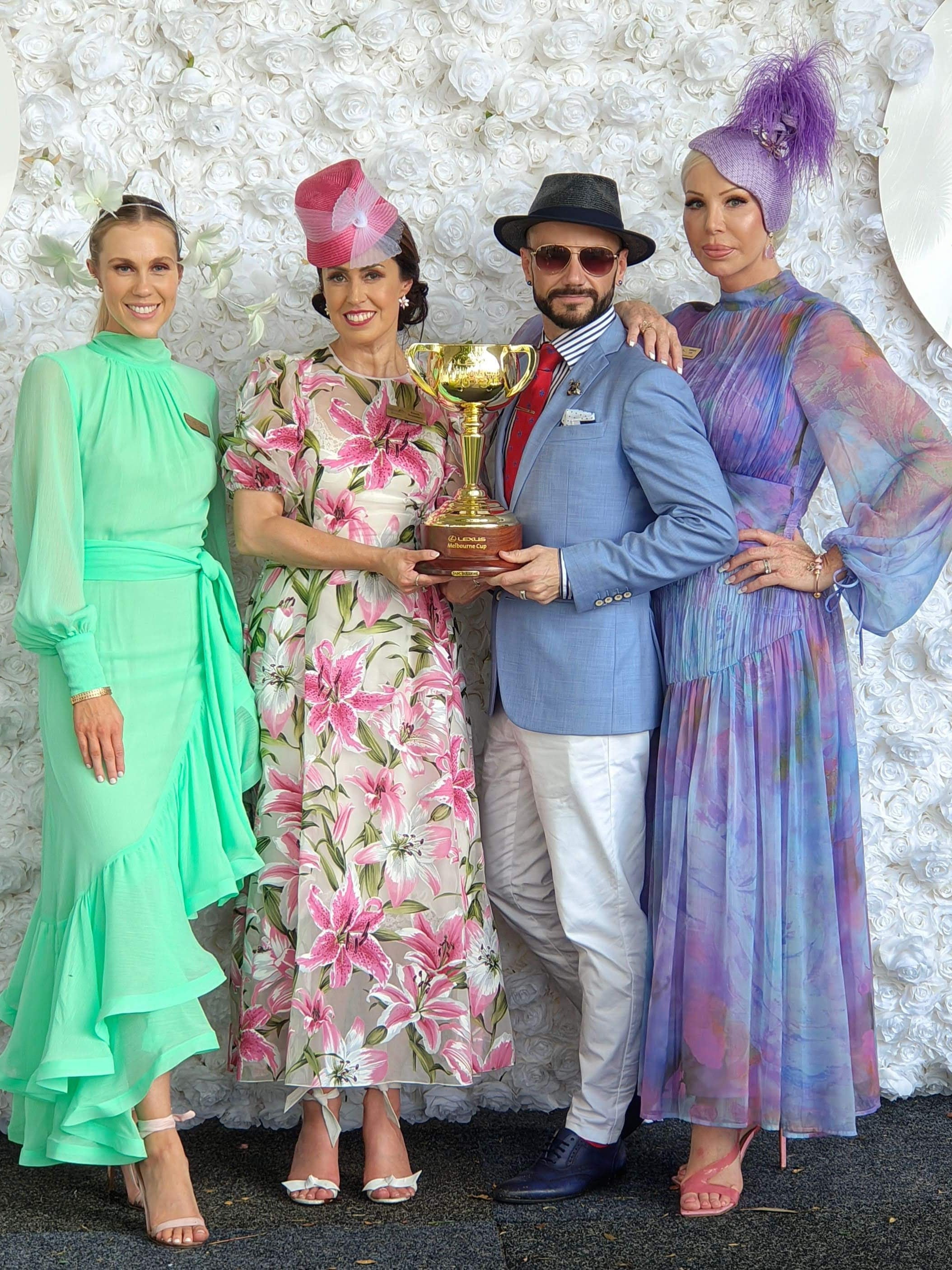 Group at Melbourne Cup holding the trophy wearing hats by Kathryn Lee Millinery - spring racing carnival