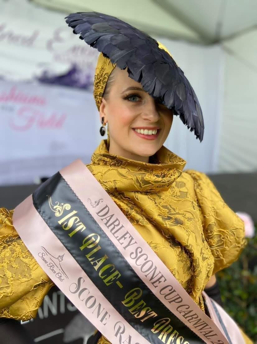 First place Best Dressed winner at Darley Scone Cup Carnival wearing navy feather headpiece by Kathryn Lee Millinery