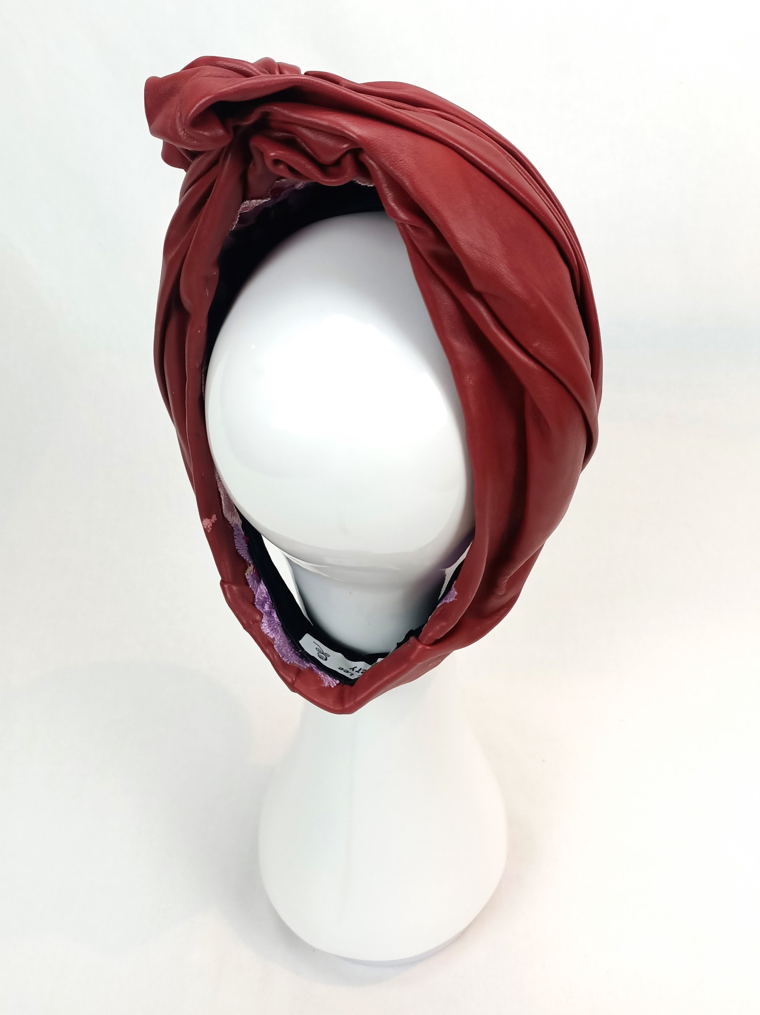 Burgundy Mirabelle turban crafted from leather – luxury racing headwear by Kathryn Lee