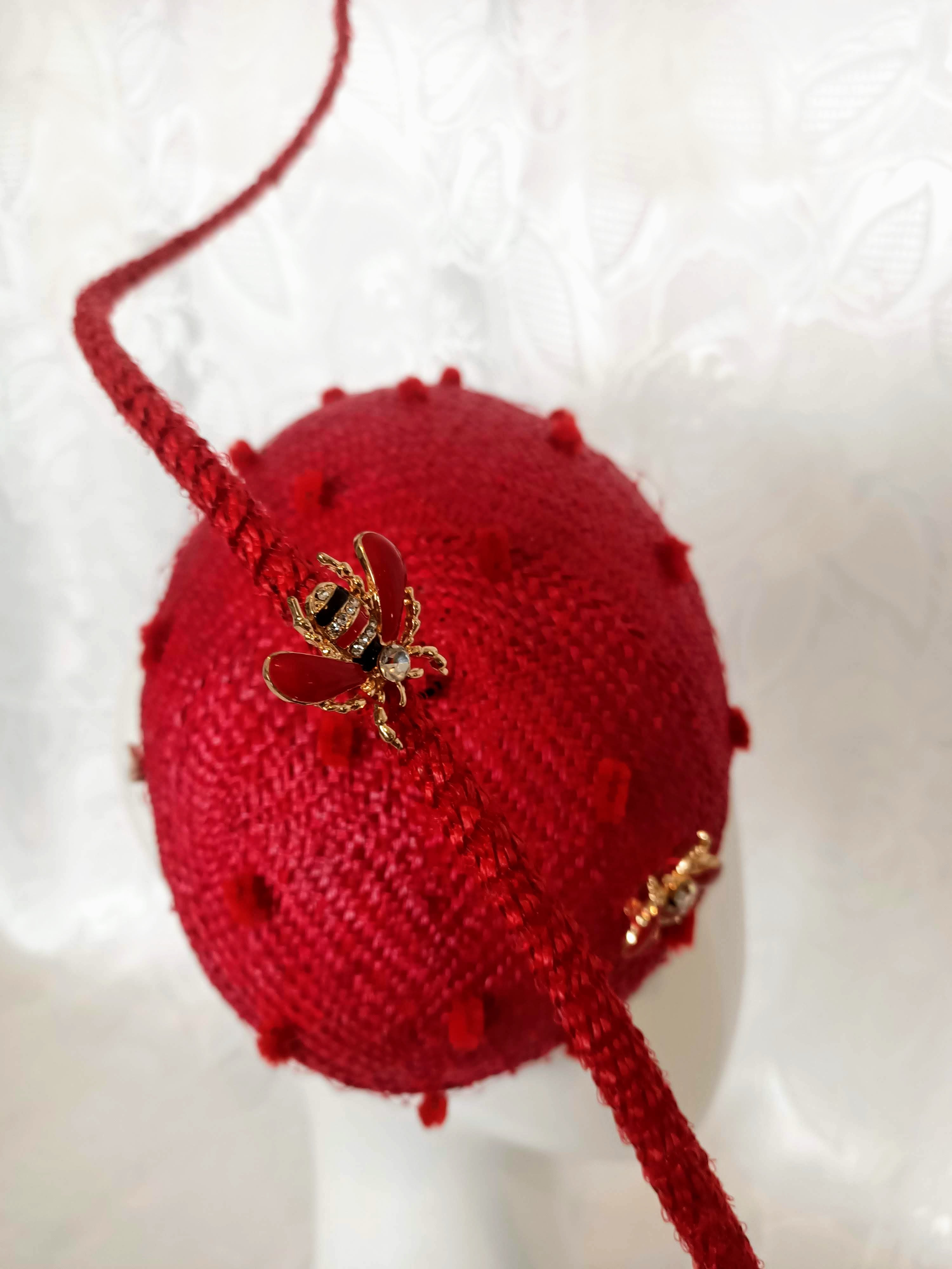 Red Straw Fascinator with Floating Quill & Ladybug Brooches – artisan millinery featuring straw for Dubai World Cup and beyond